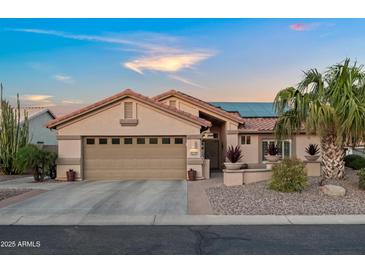 Charming single-story home featuring a two-car garage and desert landscaping at 4029 N 160Th Dr, Goodyear, AZ 85395