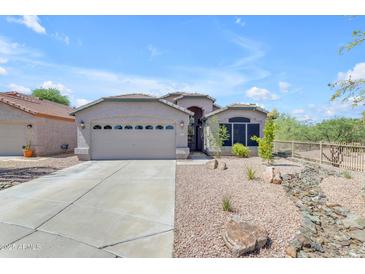 Charming single-story home with a neutral color scheme, two-car garage and well-maintained desert landscaping at 4301 E Abraham Ln, Phoenix, AZ 85050