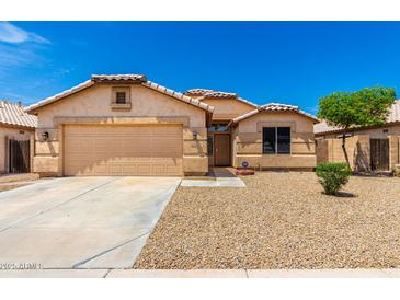 Charming single-story home featuring a two-car garage, neutral stucco exterior, and low maintenance desert landscaping at 10934 W Almeria Rd, Avondale, AZ 85392