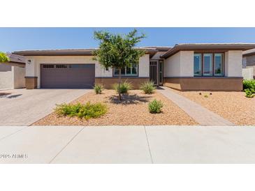 Charming single-story home featuring low-maintenance desert landscaping and a two-car garage at 1166 W Silver Creek Ln, Queen Creek, AZ 85140
