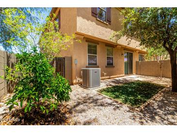 A cozy backyard area with low-maintenance landscaping and mature trees for shade at 1250 S Rialto -- # 78, Mesa, AZ 85209