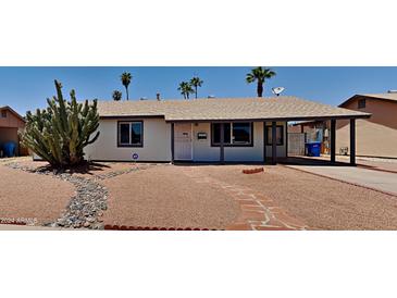 Charming single-story home featuring desert landscaping, covered entry, and a connected carport at 14002 N 38Th St, Phoenix, AZ 85032