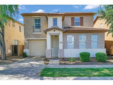 Charming two-story home featuring a neutral color scheme, attached garage, and well-maintained landscaping at 1420 E Sonrisas St, Phoenix, AZ 85040
