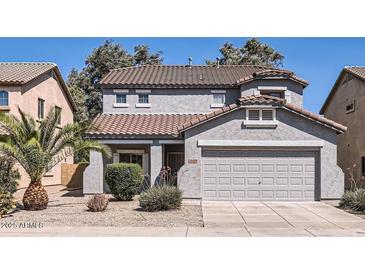Charming two-story home featuring a well-maintained front yard and attached two-car garage at 15955 N Cristine Ln, Surprise, AZ 85388
