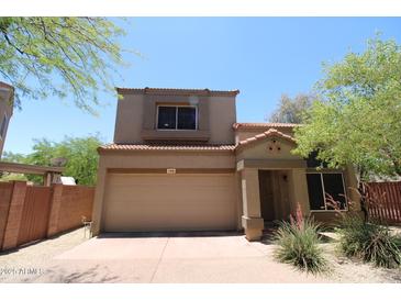 Two-story home with a neutral-colored stucco exterior, red tile roof, and a two-car garage at 17606 N 17Th Pl # 1096, Phoenix, AZ 85022
