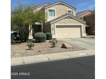 Inviting two-story home featuring a two-car garage and low-maintenance landscaping at 23284 W Pima St, Buckeye, AZ 85326