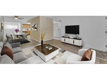 Bright living room featuring modern furnishings, decor, and a TV with a media console at 461 W Holmes Ave # 180, Mesa, AZ 85210