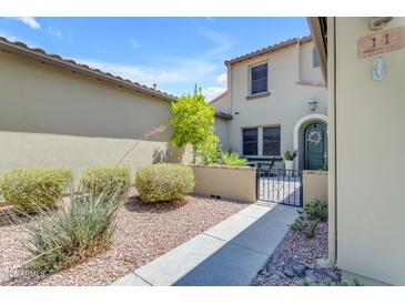 Inviting front yard with a small patio and beautiful desert landscaping leading to the home's entryway at 4700 S Fulton Ranch Blvd # 11, Chandler, AZ 85248
