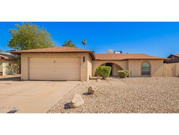 Charming single-story home with a two-car garage and low-maintenance desert landscaping at 4957 W Onyx Ave, Glendale, AZ 85302