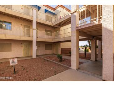 Multi-story condo complex featuring secure access and well-maintained grounds at 12123 W Bell Rd # 211, Surprise, AZ 85378
