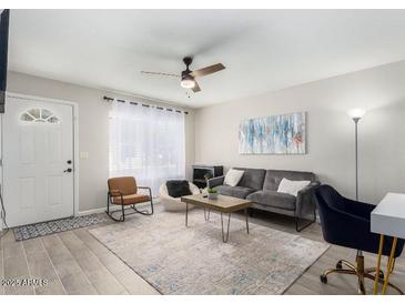 Inviting living room with wood-look tile flooring, contemporary furniture, and bright, neutral walls at 15610 N 29Th St # 3, Phoenix, AZ 85032