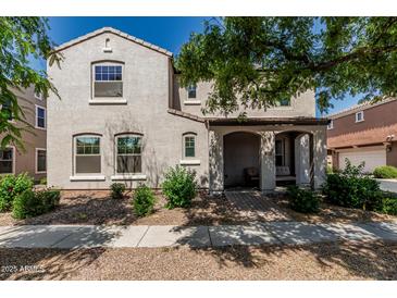 Charming two-story home with a covered front porch and manicured landscaping, great for curb appeal at 1700 S Martingale Rd, Gilbert, AZ 85295