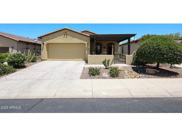 Attractive single-story home featuring a desert landscape, covered porch, and a two car garage at 17516 W Glenhaven Dr, Goodyear, AZ 85338