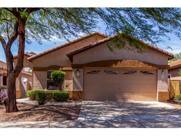 Charming single-story home featuring a two-car garage and well-maintained front yard landscaping at 2556 W Amber Sun Dr, Phoenix, AZ 85085