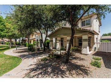 Charming two-story home with covered porch and landscaped front yard at 3037 E Hobart St, Gilbert, AZ 85296