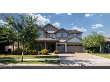 Charming two-story home showcasing a three-car garage and a beautifully landscaped front yard at 3133 E Silo Dr, Gilbert, AZ 85296