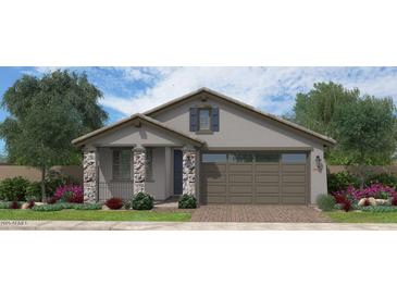 Charming single-story home with stone accents, a two-car garage, and beautiful landscaping at 35068 N Sacramento Wash Rd, San Tan Valley, AZ 85144