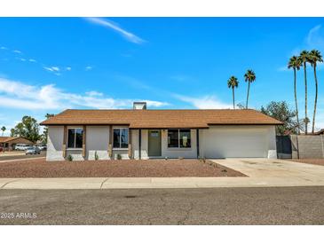 Charming single-story home featuring a well-manicured yard and attached two car garage at 3614 W Danbury Dr, Glendale, AZ 85308