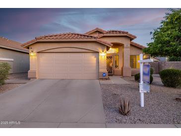Charming single-story home featuring a tile roof, arched entryway, and a two-car garage at 3713 W Nancy Ln, Phoenix, AZ 85041