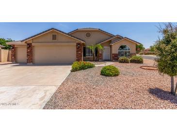 Charming single-story home with a well-manicured front yard and a two-car garage at 4307 E Shetland Dr, San Tan Valley, AZ 85140