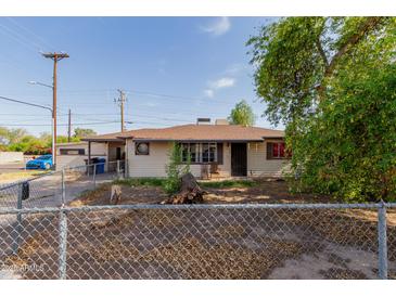Charming single-story home with desert landscaping and chain link fence at 4501 W Crittenden Ln, Phoenix, AZ 85031