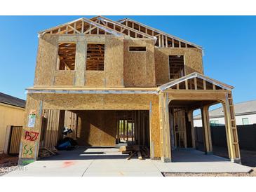 New construction home featuring a two-story framed structure, open garage, and visible interior framework at 5024 E Umber Rd, San Tan Valley, AZ 85143