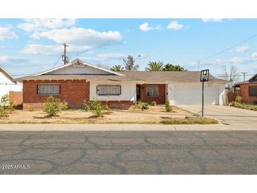 Charming single-story home with a brick exterior, well-maintained lawn, and a classic, welcoming aesthetic at 6541 N 41St Ave, Phoenix, AZ 85019