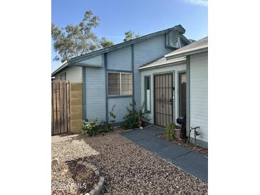 Charming single story home exterior with a secure front door and low-maintenance desert landscaping at 8155 W Desert Cove Ave, Peoria, AZ 85345