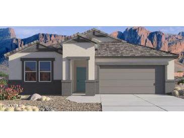 Charming single-story home with neutral stucco, desert landscaping, and a two-car garage nestled against a mountain backdrop at 8543 W Gehrig Way, Florence, AZ 85132