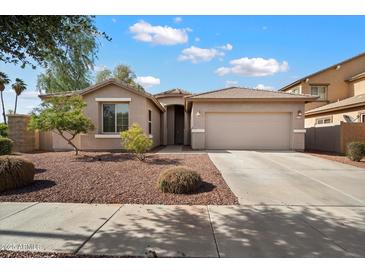 Charming single-story home featuring a two-car garage and low maintenance desert landscaping at 15910 W Fillmore St, Goodyear, AZ 85338