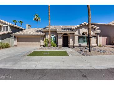 Charming single-story home featuring manicured landscaping and a tile roof at 16250 S 13Th St, Phoenix, AZ 85048
