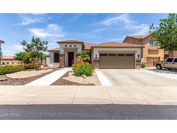 Beautiful single-story home featuring a well-manicured landscape, stone accents, and a tile roof at 17664 W Marshall Ln, Surprise, AZ 85388
