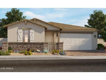 Inviting single-story home showcasing charming desert landscaping and a two-car garage at 17840 W Pierson St, Goodyear, AZ 85395