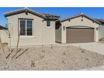 Charming single-story home featuring a two-car garage, neutral stucco, and low-maintenance desert landscaping at 19028 W Rose Ln, Waddell, AZ 85355