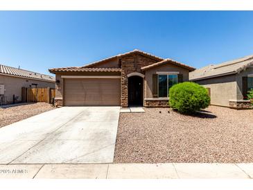 Charming single-story home featuring a two-car garage, stone accents, and low-maintenance desert landscaping at 2176 W Larissa Ln, San Tan Valley, AZ 85144