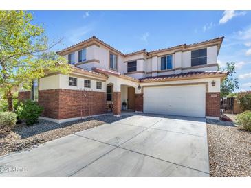 Charming two-story home boasts a brick and stucco exterior with a spacious two car garage and well maintained landscaping at 27053 N 172Nd Ln, Surprise, AZ 85387