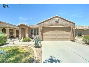 Charming single-Gathering home with a two-car garage, desert landscaping and front yard at 3128 W Belle Ave, San Tan Valley, AZ 85144