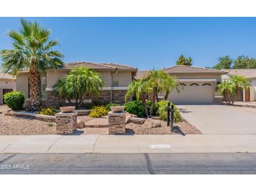 Inviting single-Gathering home with a well-manicured yard, lush landscaping, and a two-car garage at 3173 E Canyon Way, Chandler, AZ 85249