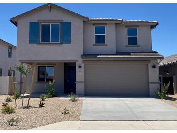 Two-story home with a two-car garage, desert landscaping, and blue shutters at 31774 N Bandit Rd, San Tan Valley, AZ 85143