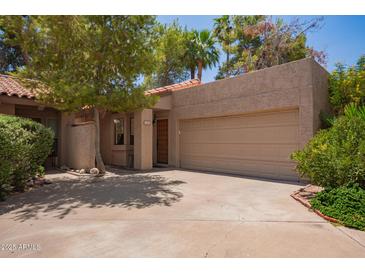 Charming desert home with a two-car garage and mature landscaping at 6422 N 77Th Way, Scottsdale, AZ 85250