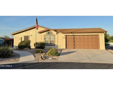Charming single-story home with a well-manicured front yard and an attached two-car garage at 8840 E Sunland Ave # 142, Mesa, AZ 85208