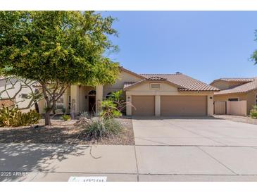 Charming single-story home with a well-maintained yard, desert landscaping, and a two-car garage at 10794 S Coolwater Dr, Goodyear, AZ 85338