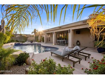 Inviting backyard oasis with a private pool and sun loungers, perfect for relaxation and entertaining at 14518 N 99Th St, Scottsdale, AZ 85260