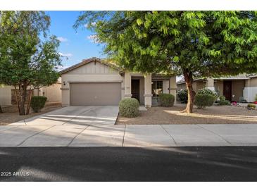 Charming single-story home featuring a neutral color scheme, well-maintained landscaping, and an attached two-car garage at 15844 W Lisbon Ln, Surprise, AZ 85379