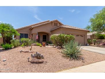 Charming single-story home featuring a well-manicured desert landscape with a cozy front porch at 17201 E Hillcrest Dr, Fountain Hills, AZ 85268