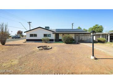 Charming single-Gathering home featuring a well-maintained lawn and a welcoming front porch, perfect for relaxed living at 2204 E Birchwood Ave, Mesa, AZ 85204