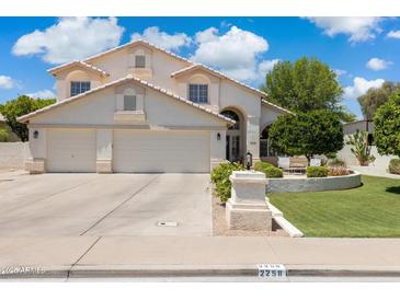 Inviting two-story home featuring a three-car garage and manicured front yard at 2258 N Gentry --, Mesa, AZ 85213