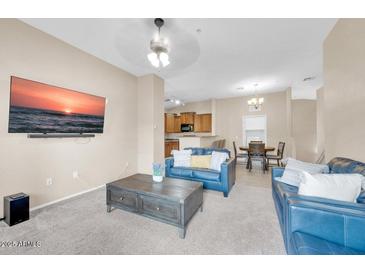 Comfortable living room with modern decor, neutral tones, and large TV mounted on the wall at 2727 N Price Rd # 6, Chandler, AZ 85224