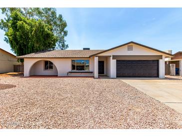 Charming single-story home with a two-car garage and low-maintenance desert landscaping at 3021 W Angela Dr, Phoenix, AZ 85053