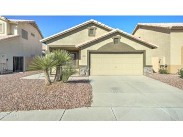 Charming home featuring a two-car garage, complemented by desert landscaping and a well-maintained facade at 4050 E Agave Rd, Phoenix, AZ 85044